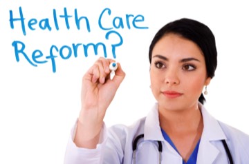 doctor writing the words health care reform on white board