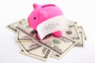 piggy bank with 401k sign on top of cash